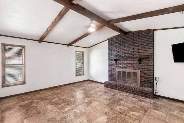 unfurnished living room featuring a fireplace, vaulted ceiling with beams, and plenty of natural light