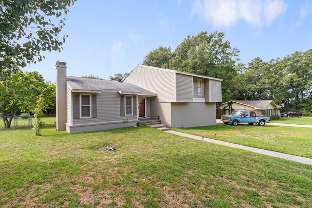 split level home featuring a front lawn