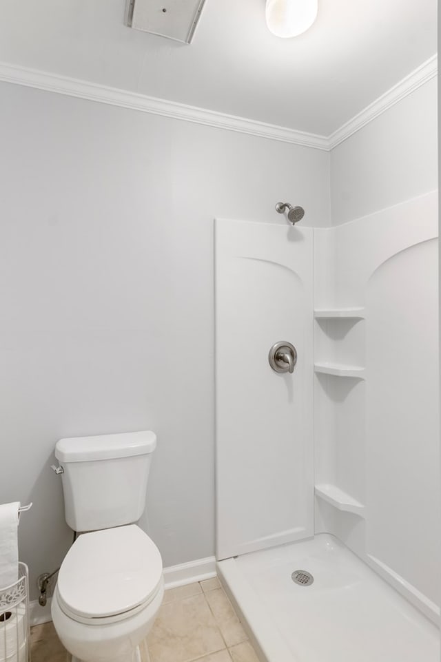 bathroom featuring crown molding, tile patterned flooring, a shower, and toilet