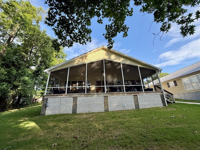 683 B Calhoun Dr, Abbeville, AL 36310 - back of property with a sunroom, a lawn, a ceiling fan, and stairway