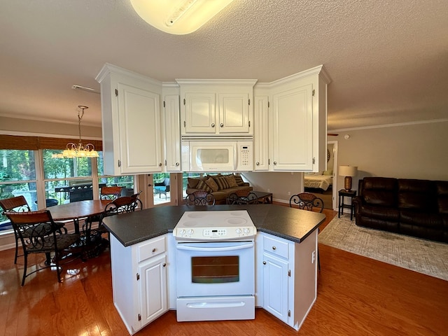 683 B Calhoun Dr, Abbeville, AL 36310 - kitchen with white appliances, dark countertops, a chandelier, white cabinets, and ornamental molding