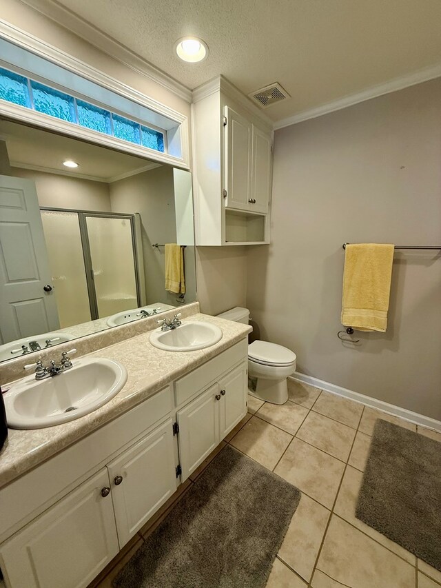 683 B Calhoun Dr, Abbeville, AL 36310 - bathroom with a shower stall, double vanity, tile patterned floors, and crown molding