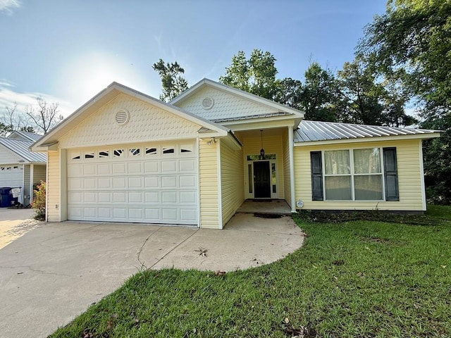 683 B Calhoun Dr, Abbeville, AL 36310 - view of front of house with driveway, a garage, and a front lawn