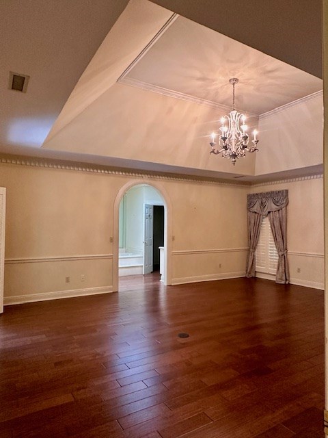 6 Woodmere Dr, Dothan, AL 36305 - spare room featuring a chandelier, arched walkways, wood finished floors, and crown molding