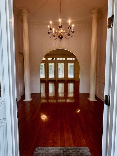 6 Woodmere Dr, Dothan, AL 36305 - entrance foyer featuring wood finished floors, arched walkways, a chandelier, ornate columns, and ornamental molding