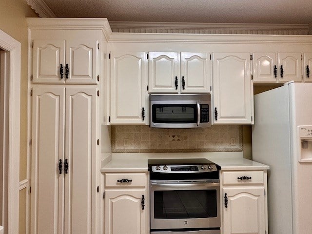 6 Woodmere Dr, Dothan, AL 36305 - kitchen with appliances with stainless steel finishes, light countertops, tasteful backsplash, crown molding, and white cabinetry