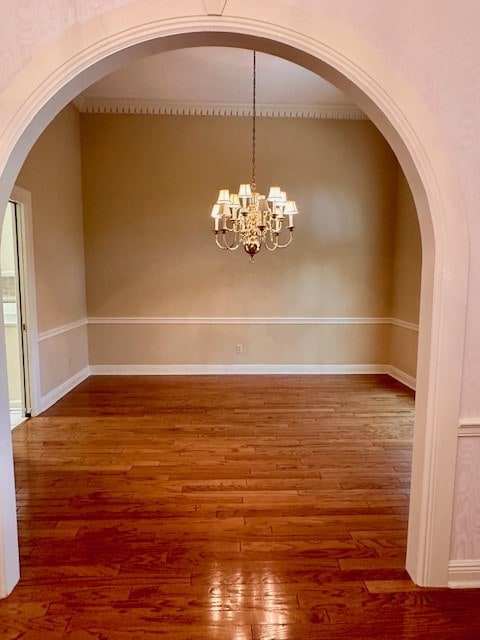 6 Woodmere Dr, Dothan, AL 36305 - unfurnished room with wood finished floors, arched walkways, and a chandelier