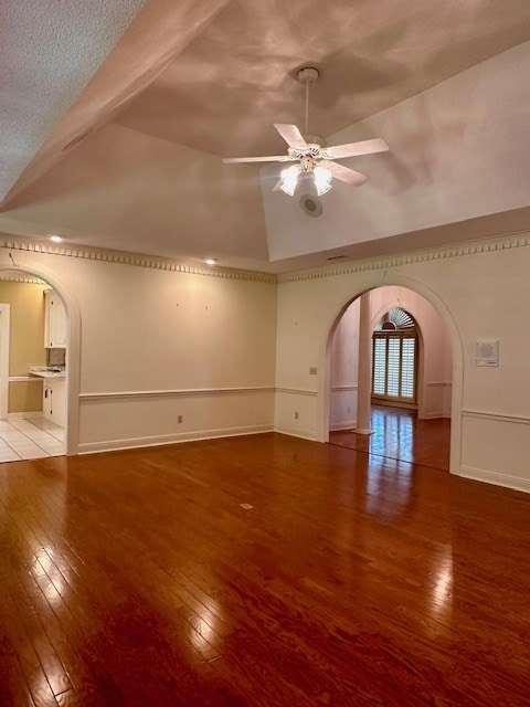 6 Woodmere Dr, Dothan, AL 36305 - unfurnished living room with arched walkways, hardwood / wood-style floors, ceiling fan, and lofted ceiling