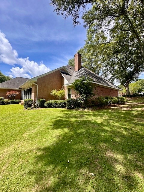 6 Woodmere Dr, Dothan, AL 36305 - view of side of property with brick siding, a yard, and a chimney