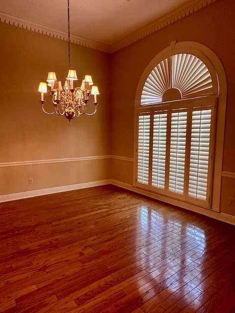 6 Woodmere Dr, Dothan, AL 36305 - unfurnished room featuring a chandelier, wood-type flooring, and crown molding