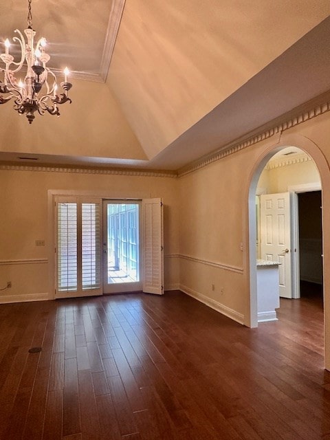 6 Woodmere Dr, Dothan, AL 36305 - unfurnished living room with a chandelier, crown molding, arched walkways, dark wood finished floors, and vaulted ceiling