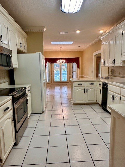 6 Woodmere Dr, Dothan, AL 36305 - kitchen with appliances with stainless steel finishes, a chandelier, a peninsula, light countertops, and crown molding