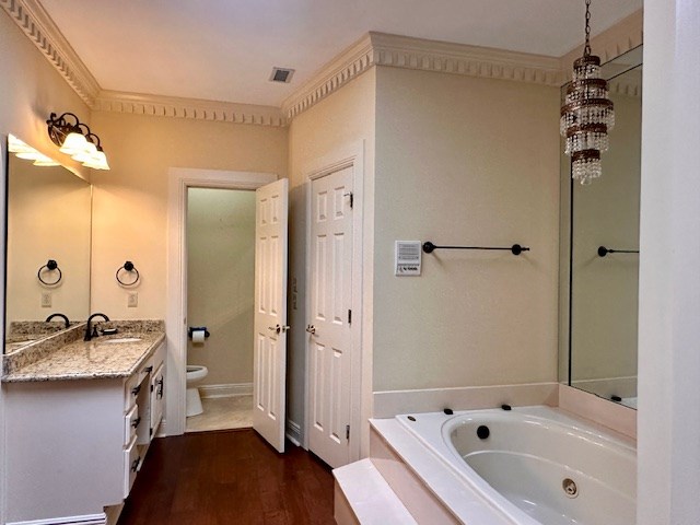 6 Woodmere Dr, Dothan, AL 36305 - bathroom featuring vanity, a whirlpool tub, and wood finished floors