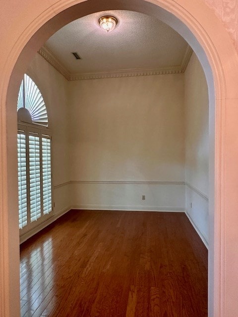 6 Woodmere Dr, Dothan, AL 36305 - spare room featuring dark wood-type flooring, arched walkways, and ornamental molding