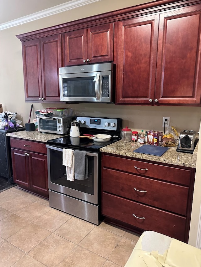 112 Covenant Dr, Dothan, AL 36303 - kitchen featuring stainless steel appliances, dark brown cabinets, light tile patterned flooring, ornamental molding, and light stone counters