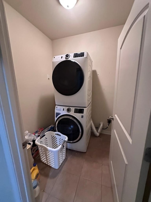 112 Covenant Dr, Dothan, AL 36303 - laundry room featuring stacked washer / dryer and light tile patterned flooring
