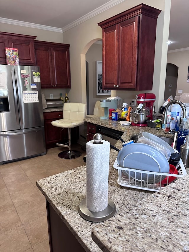 112 Covenant Dr, Dothan, AL 36303 - kitchen with stainless steel fridge, arched walkways, light tile patterned flooring, ornamental molding, and reddish brown cabinets