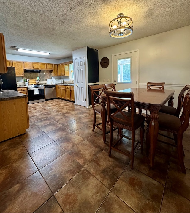 109 Pinehurst Dr, Ashford, AL 36312 - dining area with a textured ceiling, dark tile patterned floors, and a chandelier