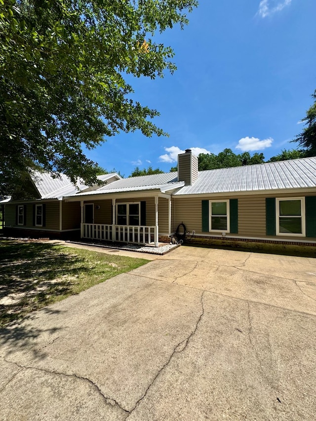 109 Pinehurst Dr, Ashford, AL 36312 - back of property featuring a metal roof, a chimney, and covered porch