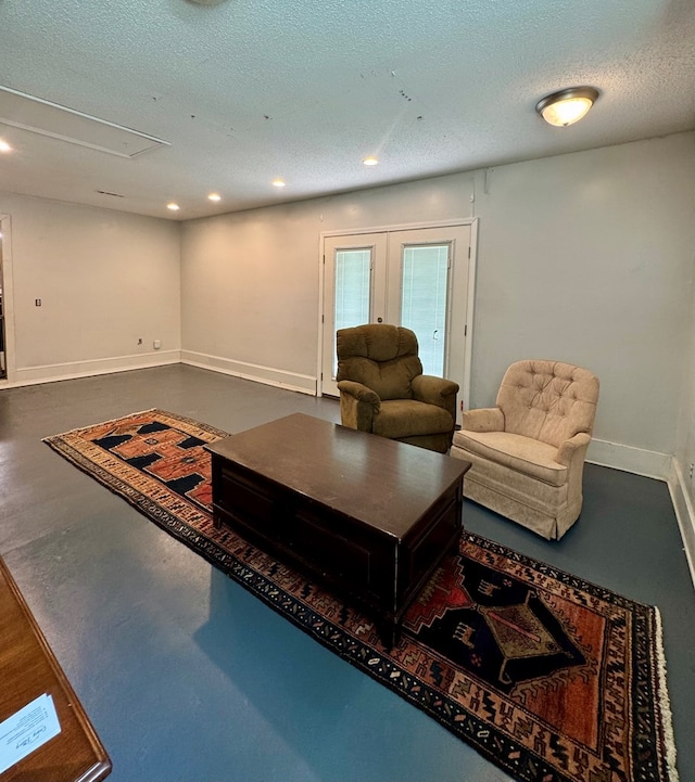 109 Pinehurst Dr, Ashford, AL 36312 - living room featuring finished concrete floors, french doors, a textured ceiling, recessed lighting, and attic access