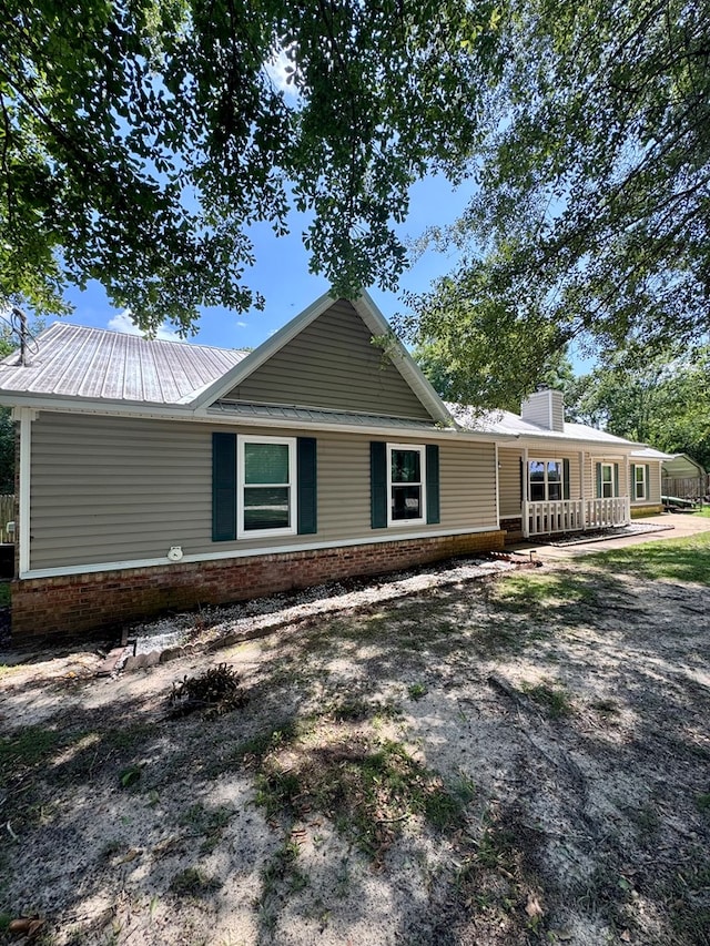 109 Pinehurst Dr, Ashford, AL 36312 - view of front of home featuring a porch, a metal roof, brick siding, and a chimney