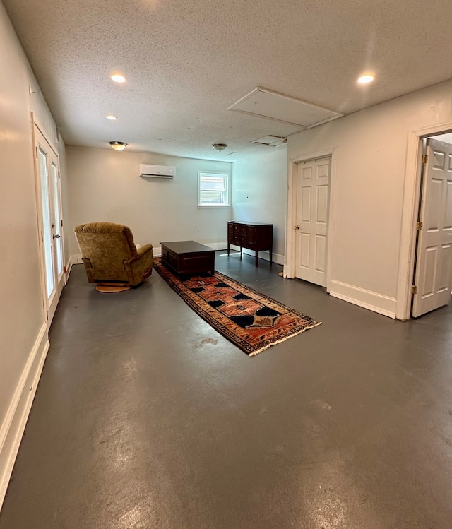 109 Pinehurst Dr, Ashford, AL 36312 - living area with a wall mounted AC, attic access, finished concrete flooring, a textured ceiling, and recessed lighting