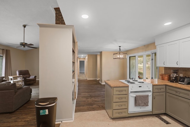 kitchen featuring electric stove, pendant lighting, gray cabinets, and ceiling fan with notable chandelier