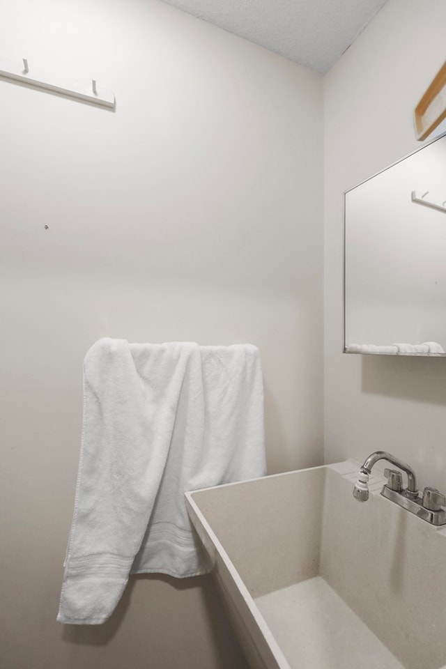 bathroom with sink and a textured ceiling