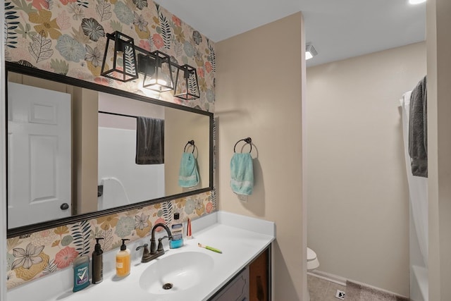 bathroom featuring vanity and toilet