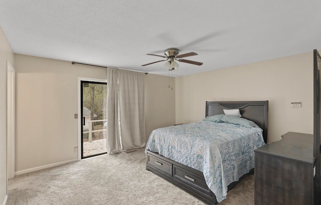 carpeted bedroom featuring ceiling fan, access to exterior, and a textured ceiling