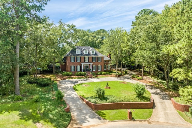 exterior space featuring a front lawn and brick siding