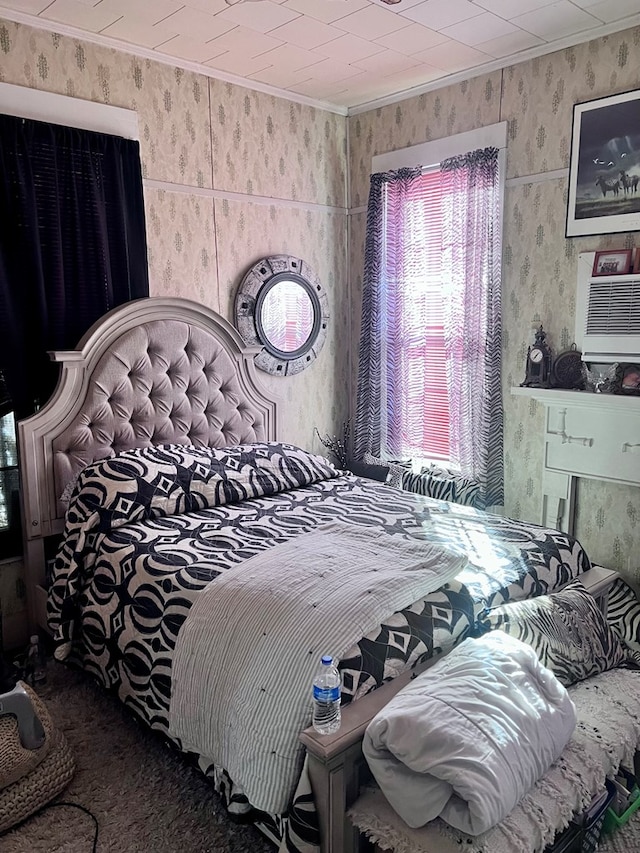 bedroom featuring ornamental molding, a wall mounted AC, and wallpapered walls