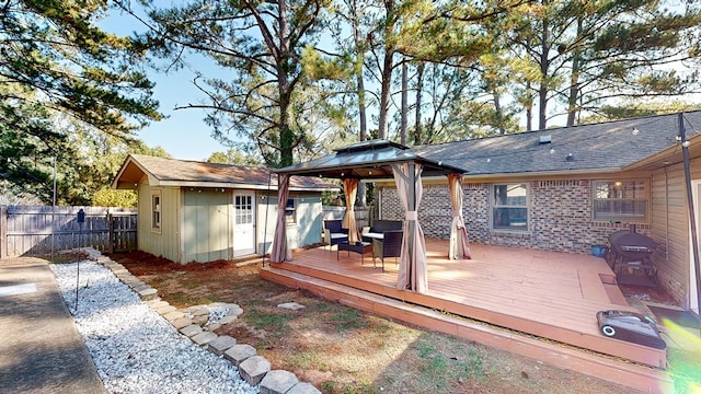 back of property featuring a gazebo and a deck