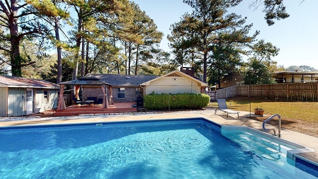 view of swimming pool featuring a yard, a patio, and a wooden deck