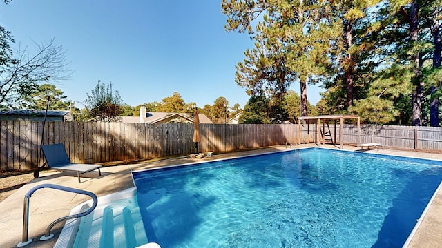 view of pool featuring a diving board