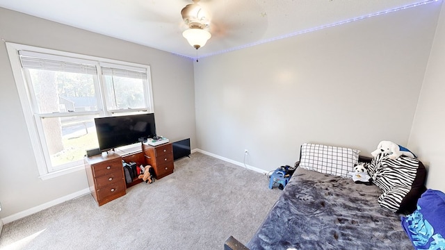 interior space with ceiling fan and light colored carpet