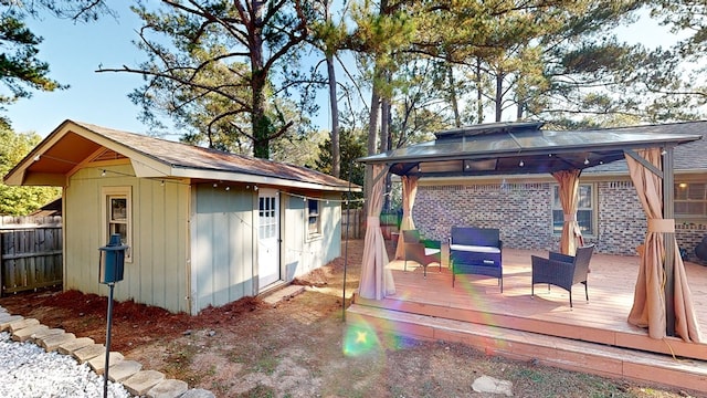 deck with a gazebo and a storage unit