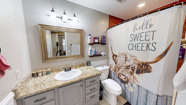 bathroom featuring tile patterned flooring, vanity, curtained shower, and toilet