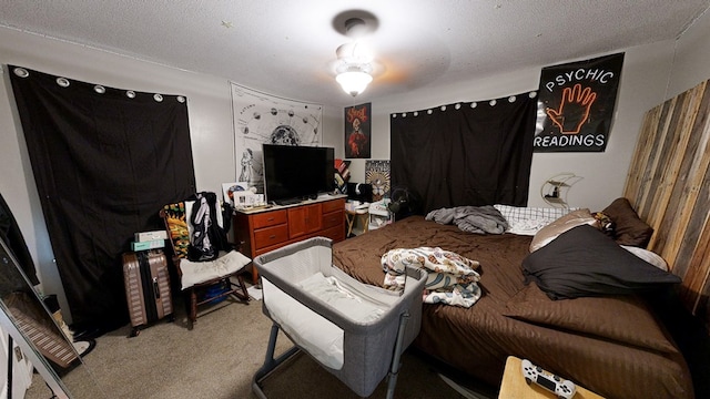 bedroom featuring a textured ceiling and light carpet