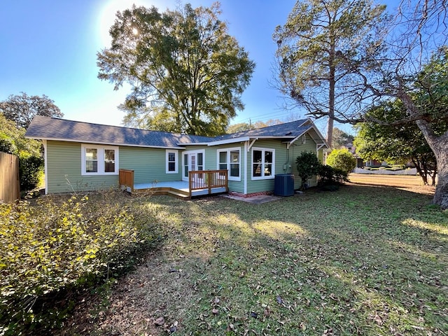 view of front of house with central AC unit, a deck, and a front lawn