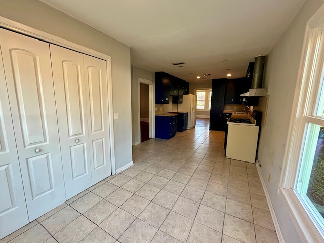 kitchen featuring white appliances and light tile patterned floors