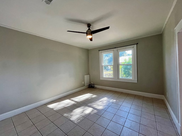 empty room featuring ceiling fan, ornamental molding, and light tile patterned flooring