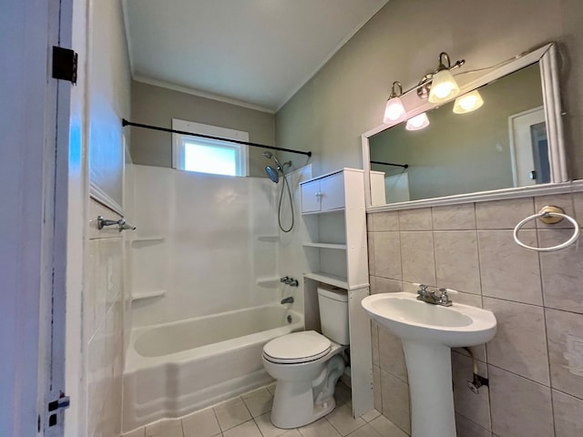 bathroom featuring shower / bath combination, tile patterned floors, tasteful backsplash, tile walls, and toilet