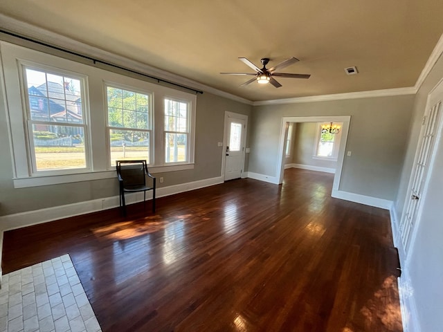 interior space featuring ceiling fan with notable chandelier, ornamental molding, and dark wood-type flooring