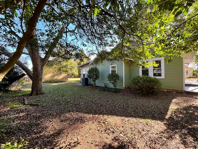 view of side of home with central AC unit