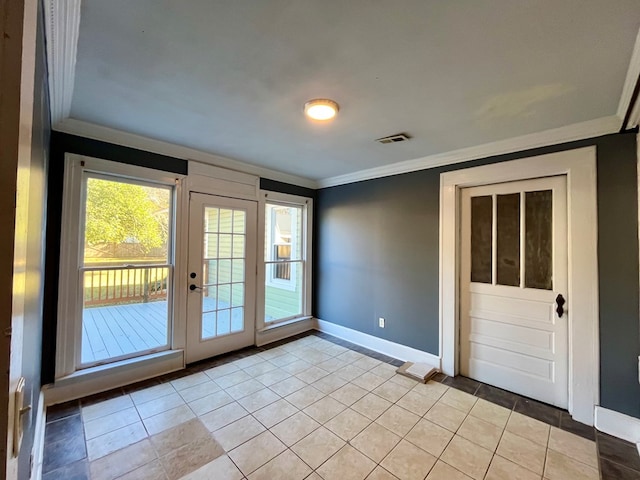 entryway with light tile patterned floors and crown molding