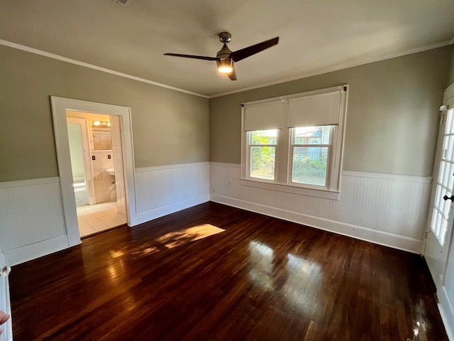 unfurnished bedroom with crown molding, ceiling fan, dark wood-type flooring, and ensuite bathroom