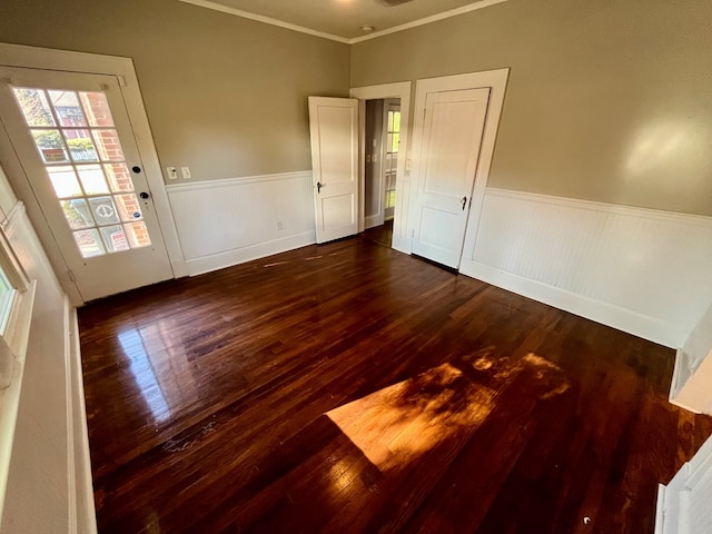 spare room with dark hardwood / wood-style floors and crown molding