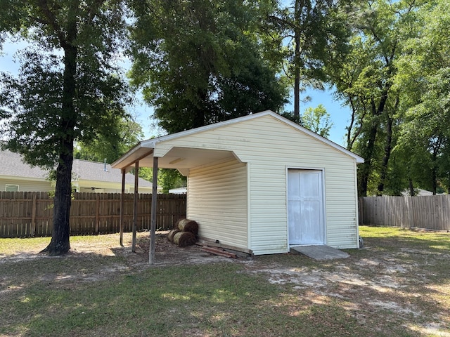view of outdoor structure with a fenced backyard and an outdoor structure