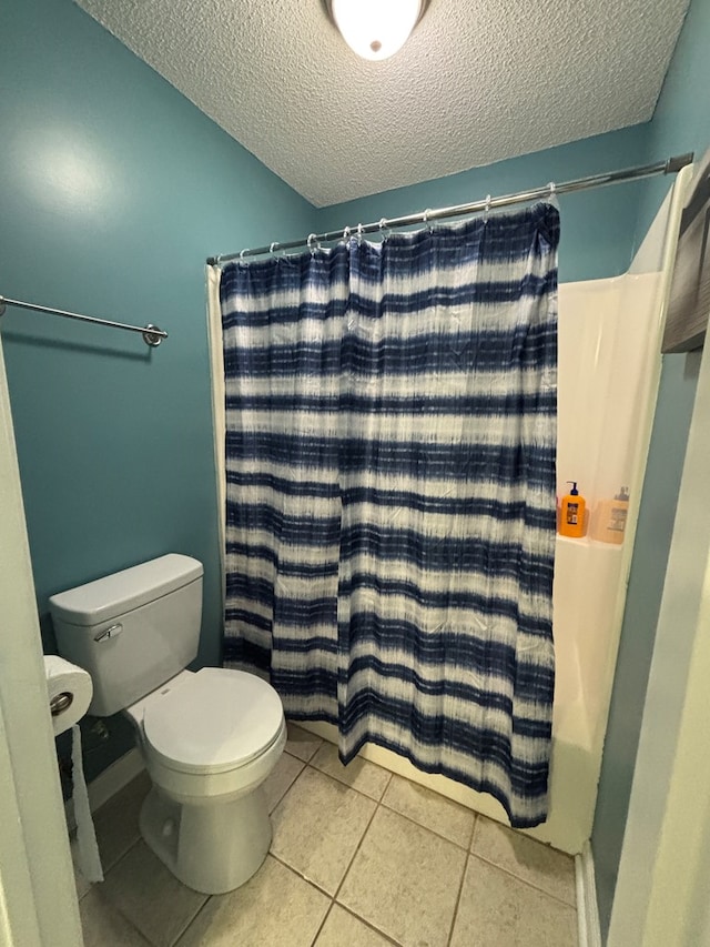 bathroom featuring a shower with curtain, a textured ceiling, tile patterned flooring, and toilet